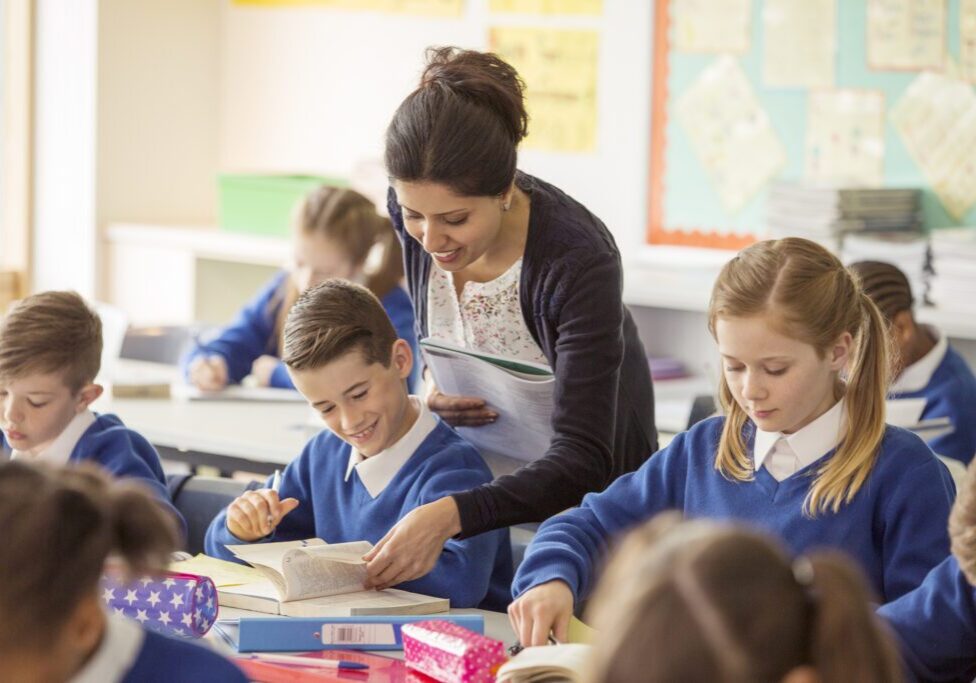 Female teacher with her pupils in classroom